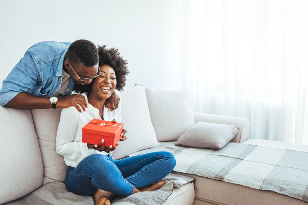 couple exchange gifts at home