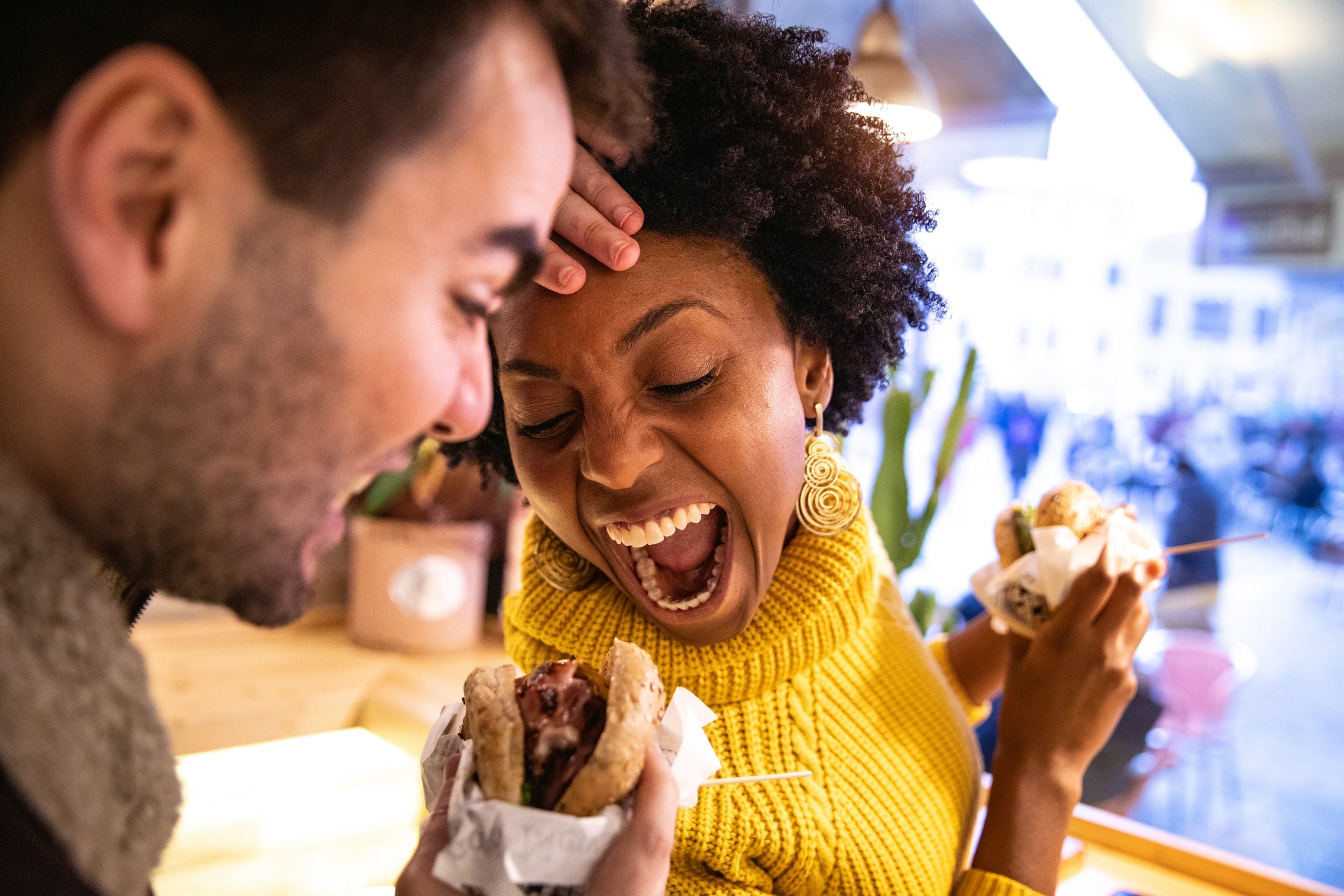 Friends playing while eating a burger