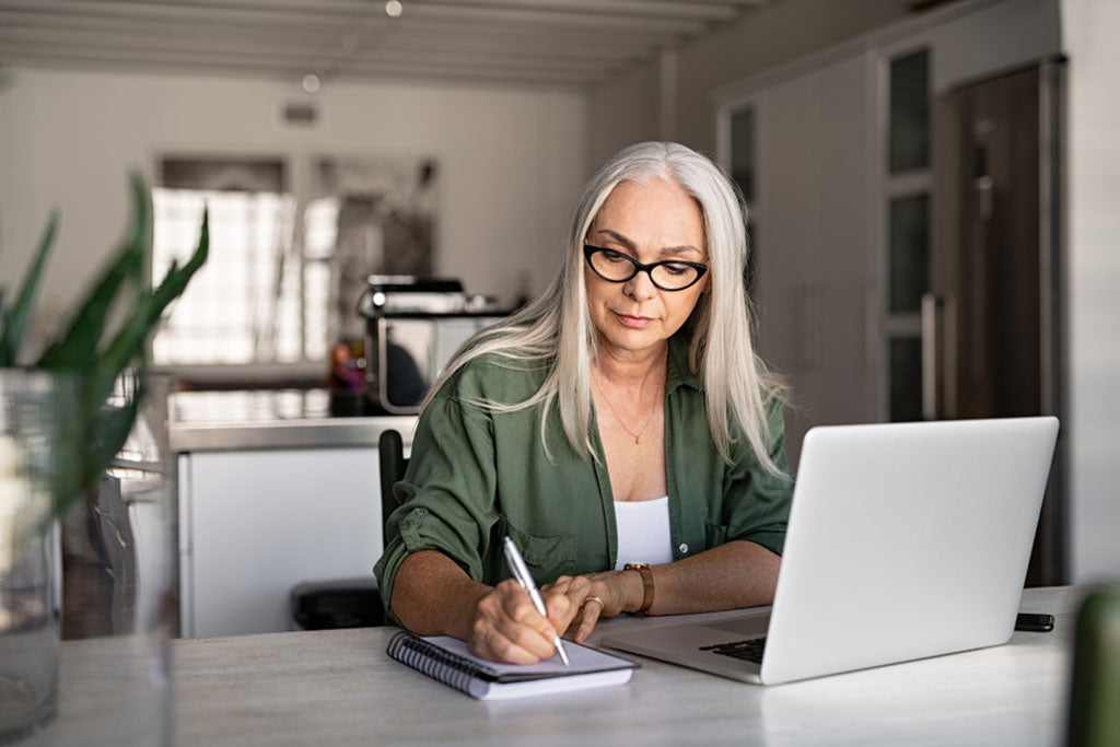 woman using internet writing notes