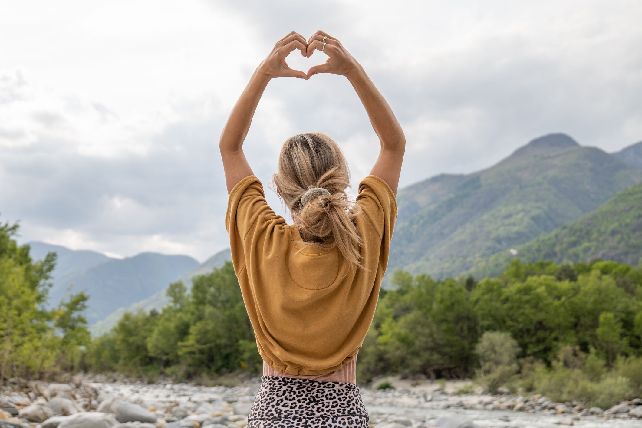 She stands on a rock by the river, forest and mountains on background.
Ticino canton, Switzerland