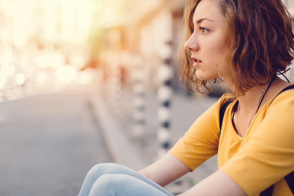 Teenage girl staring at the street