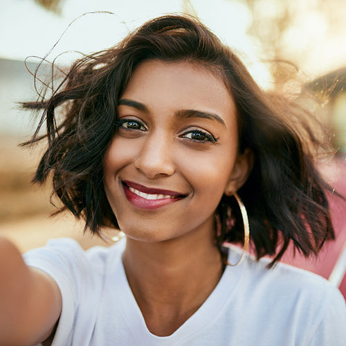 A vibrant Asian woman smiling.