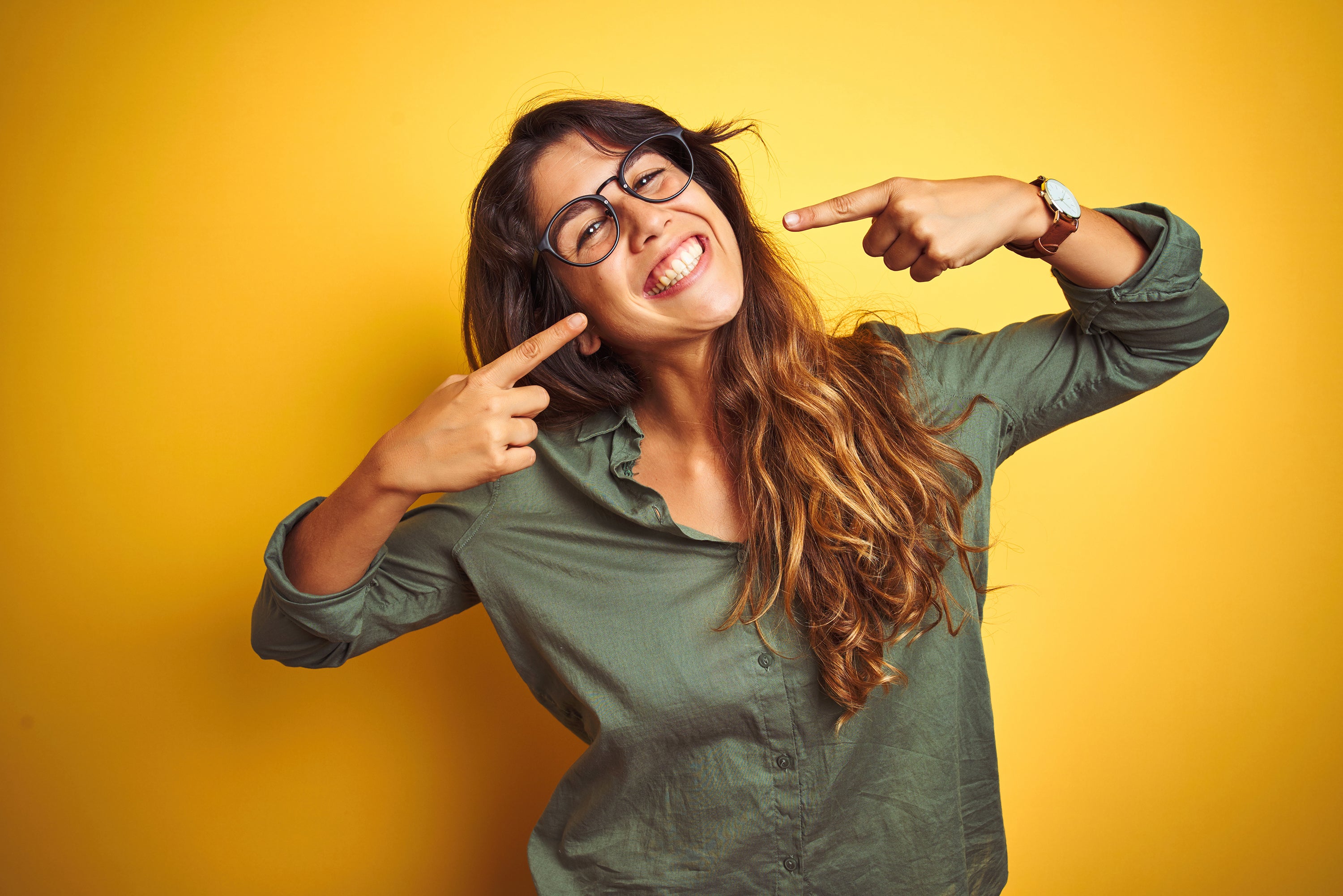 Young woman wearing thick framed glasses while smiling